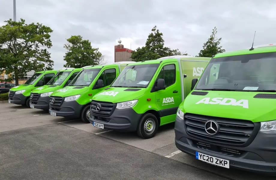 Asda home delivery vans lined up in a depot yard for Dynamon ZERO fleet electrification case study