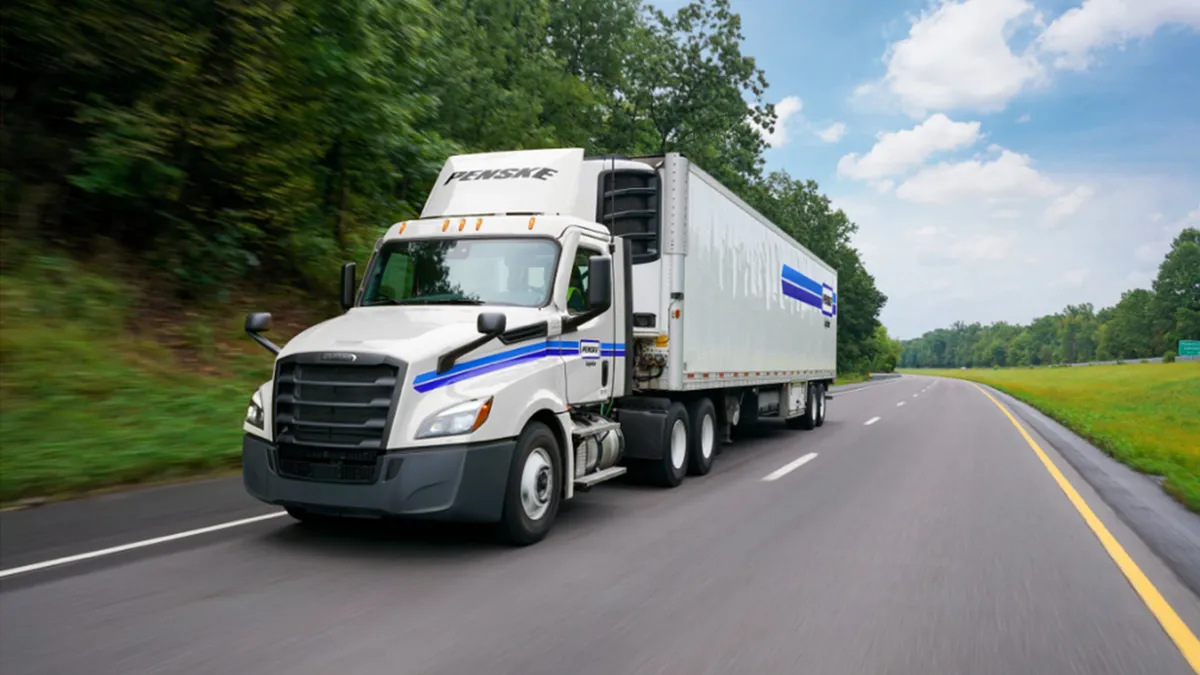 White Penske tractor-trailer on a US highway from the Bridgestone and Penske Decarbonization Lab case study with Dynamon