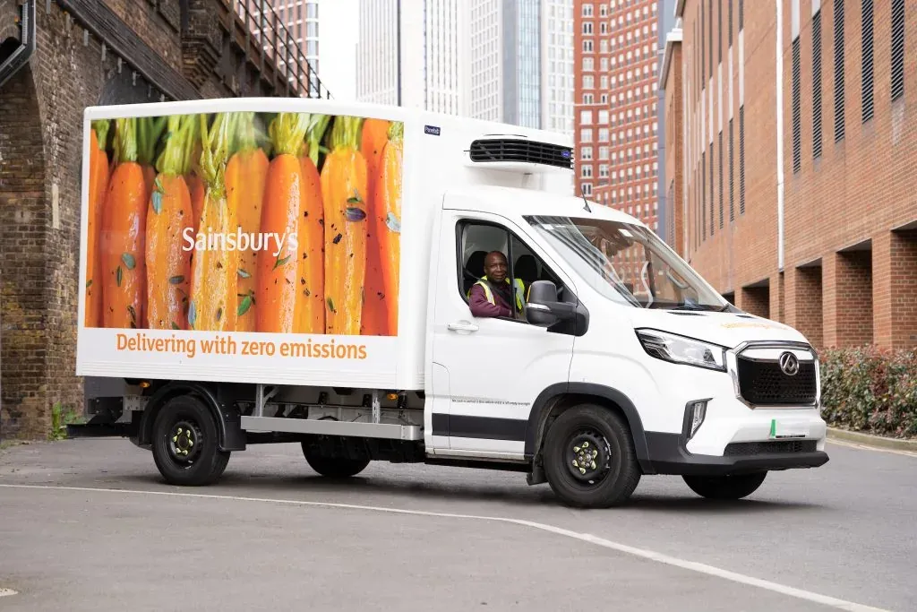 White Sainsbury’s electric home-delivery van with a carrot livery and the line Delivering with zero emissions